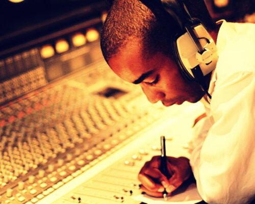 Peter sat at a sound-desk, headphones on