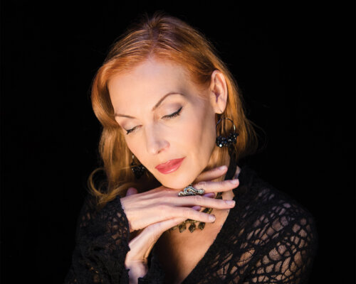 White woman in lace dress in a classic glamour pose