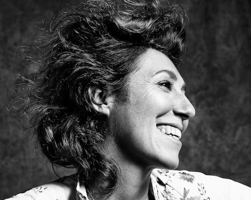 Martha smiling and looking away in black and white
